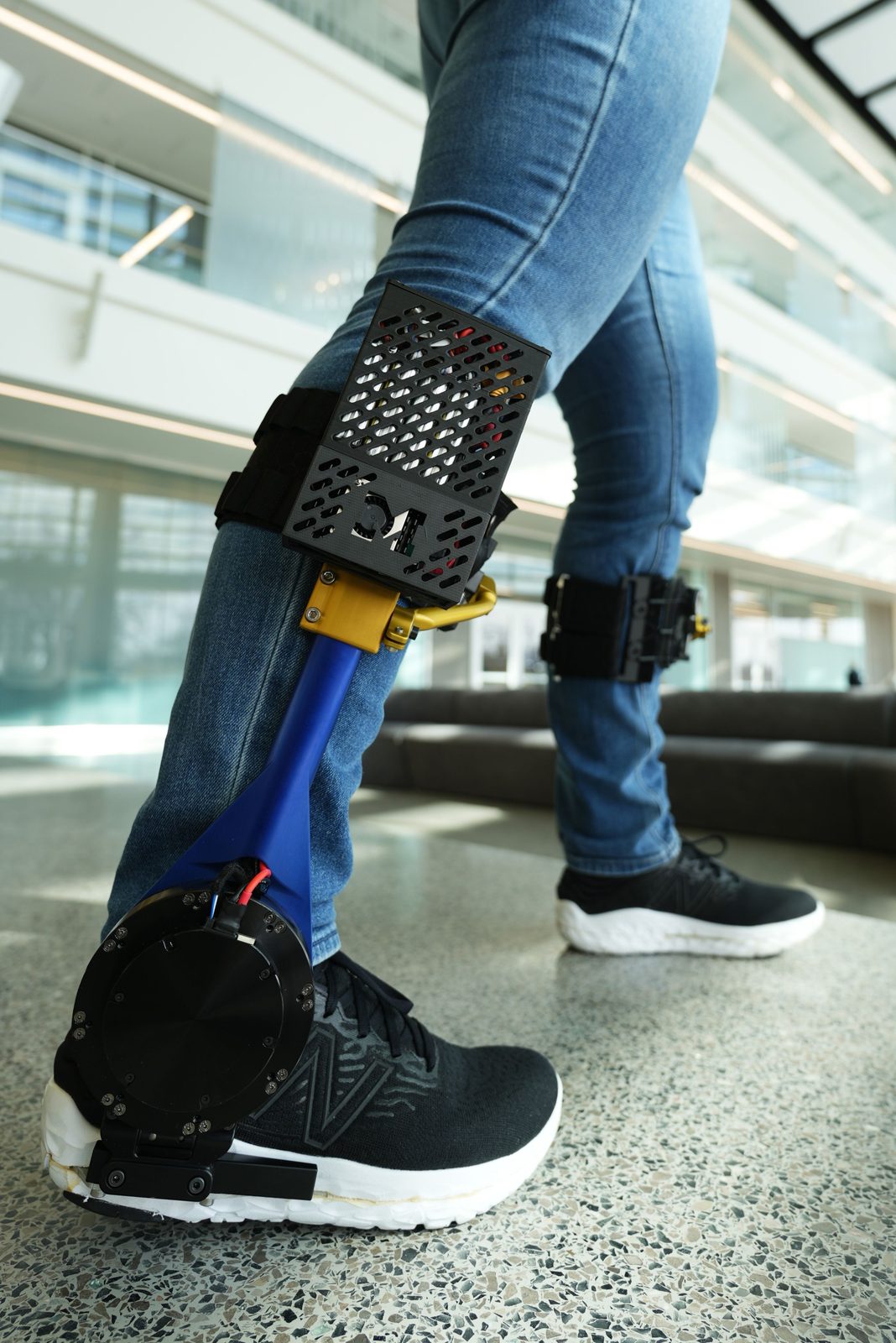 A powered ankle exoskeleton worn on the lower leg, with the actuator at the ankle joint.