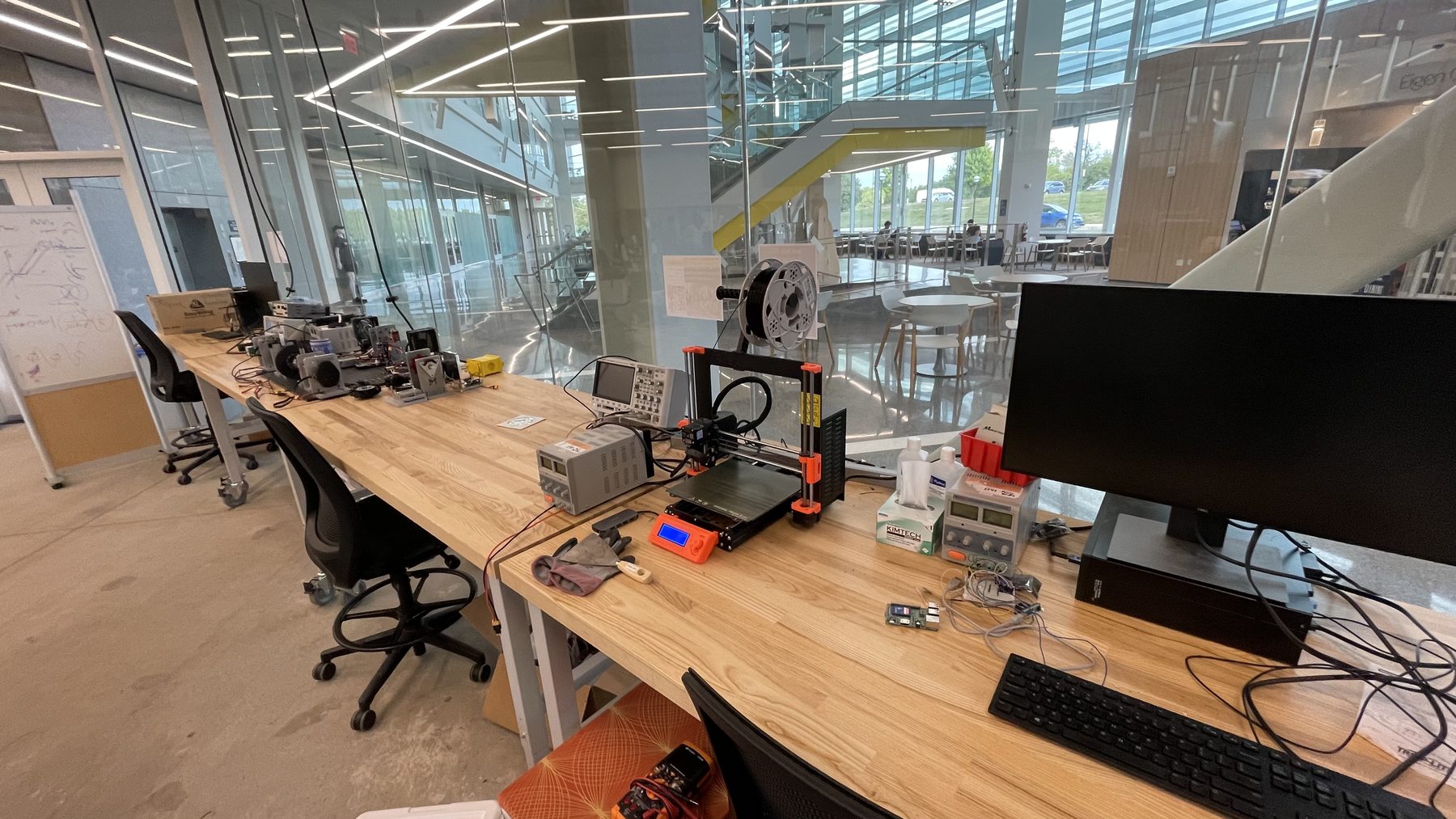 Benchtop assembly space with tools and exoskeleton components.