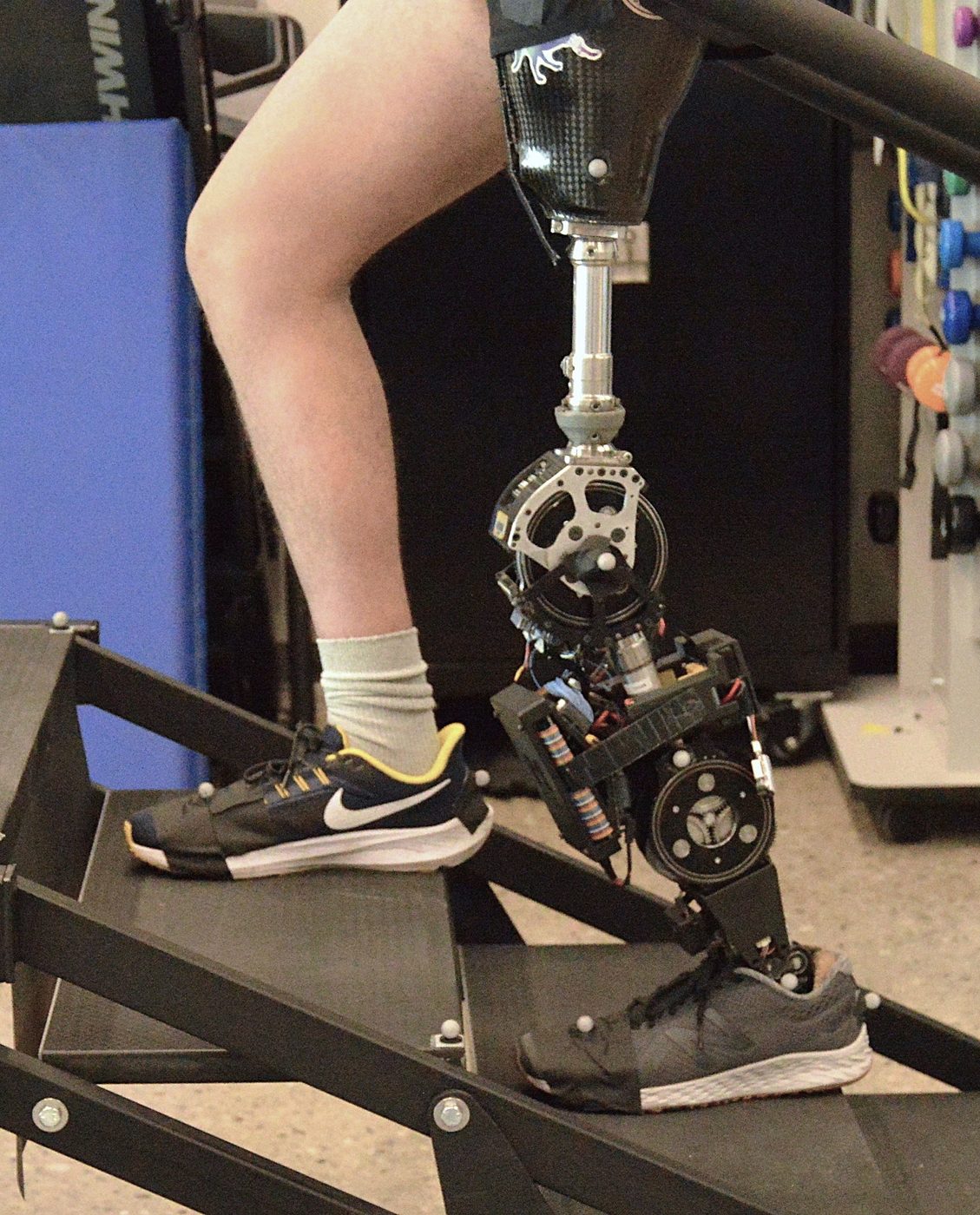 A participant ascends laboratory stairs wearing the LocoLab Leg2 powered knee-ankle prosthesis.