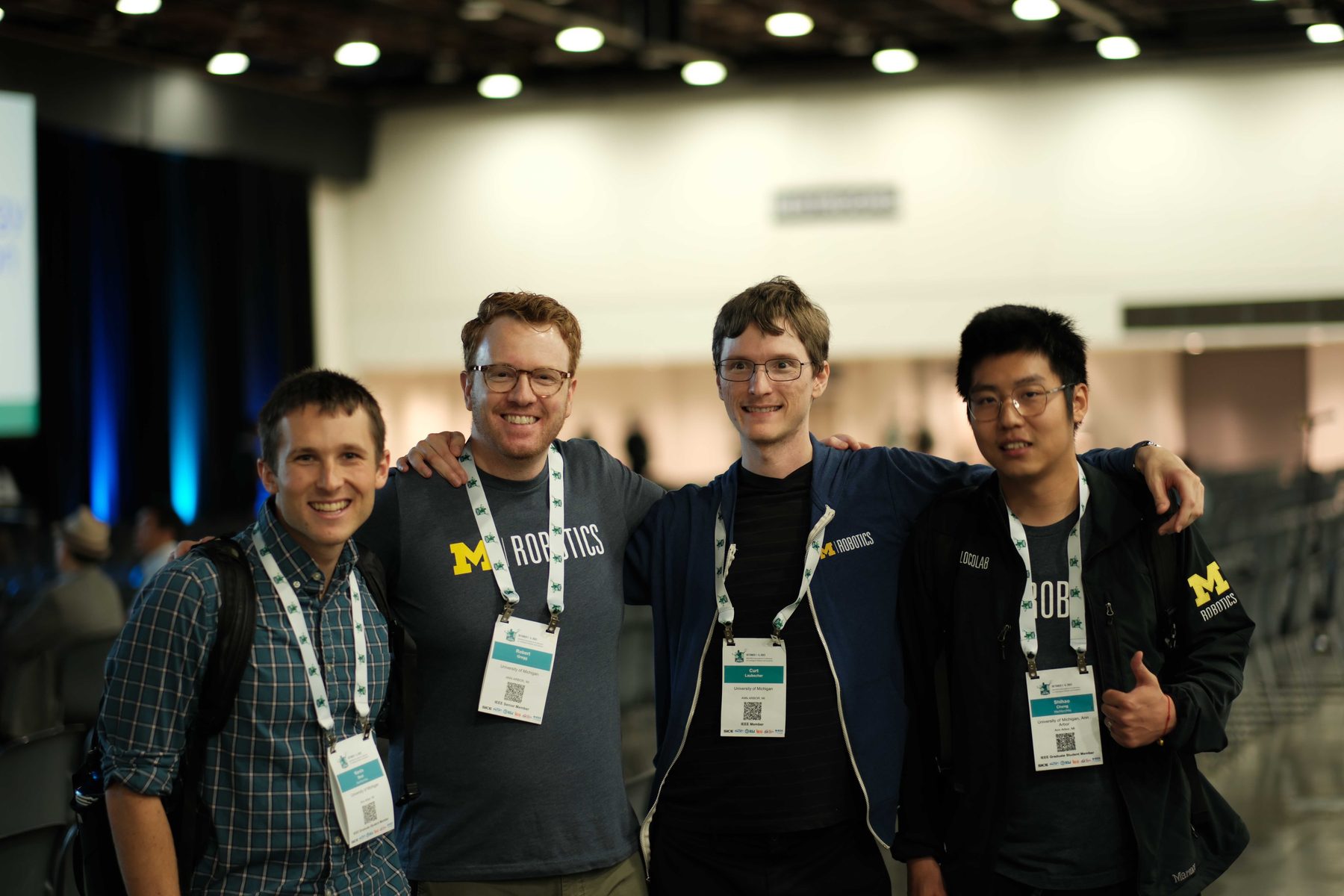 Four lab members at the IEEE/RSJ International Conference on Intelligent Robots and Systems.